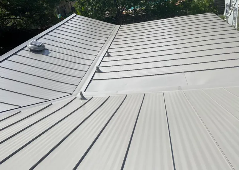 Solar attic fan installed on a metal roof for Roof Ventilation in Faribault